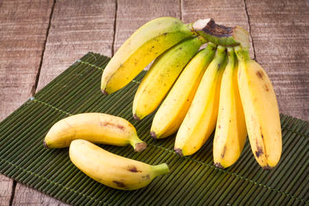 banana fruit on the wooden table (Musa Ã paradisiaca).の写真素材