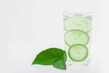 glass with water and lemon isolated on white background.の写真素材