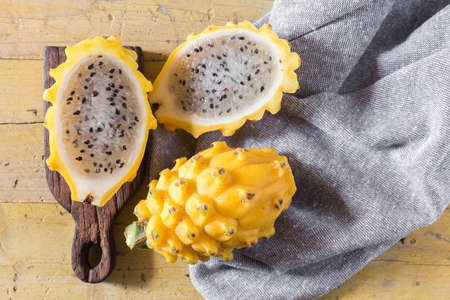 yellow pitahaya dragon fruit on wooden backgroundの写真素材
