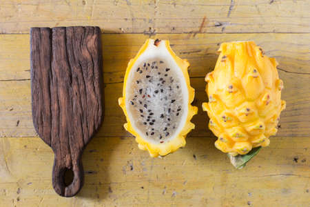 yellow pitahaya dragon fruit on wooden backgroundの写真素材