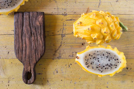 yellow pitahaya dragon fruit on wooden backgroundの写真素材