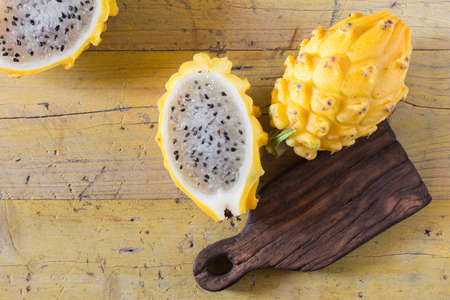 yellow pitahaya dragon fruit on wooden backgroundの写真素材