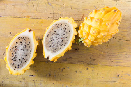 yellow pitahaya dragon fruit on wooden backgroundの写真素材