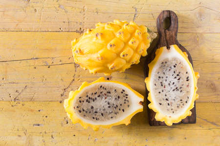 yellow pitahaya dragon fruit on wooden backgroundの写真素材