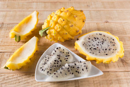 yellow pitahaya dragon fruit on wooden backgroundの写真素材