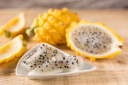 yellow pitahaya dragon fruit on wooden backgroundの写真素材