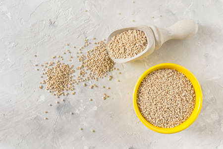 organic quinua cereal in color bowl on white backgroundの写真素材