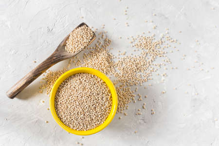 organic quinua cereal in color bowl on white backgroundの写真素材