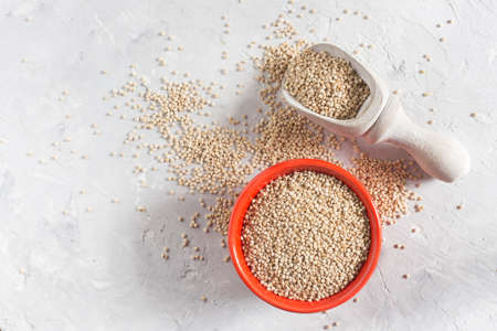 organic quinua cereal in color bowl on white backgroundの写真素材