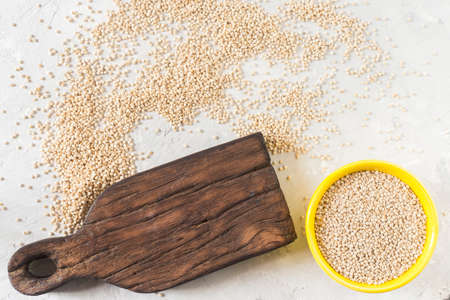 organic quinua cereal in color bowl on white background