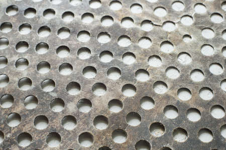 old steel sheet with circular perforations.の写真素材