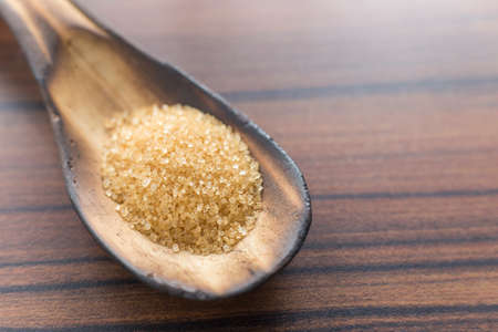 brown sugar in the spoon on the tableの写真素材