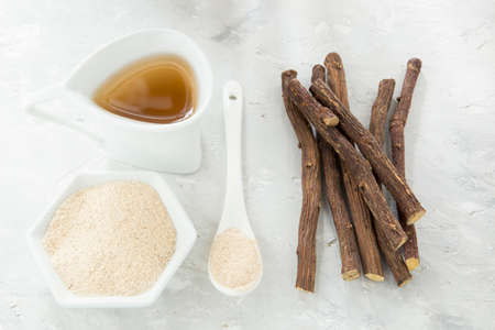 Licorice tea, powder and roots on the tableの写真素材