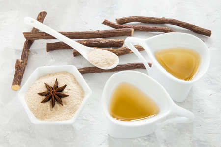 anise tea and liquorice roots on the tableの写真素材