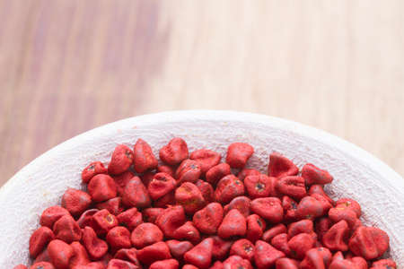 annatto beans in bowl on the table seen from up close.の写真素材