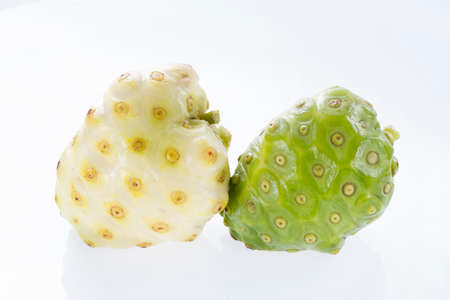 Noni fruits isolated on white background, Morinda citrifolia.の写真素材