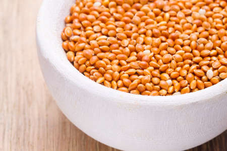 red millet in bowl on the table close up.の写真素材