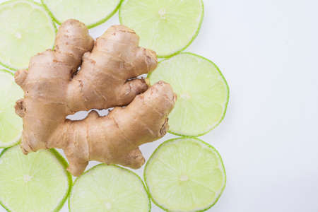 ginger root and slices of lemon on white background.の写真素材