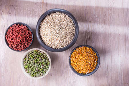 collection of super foods in several containers arranged randomly on the table