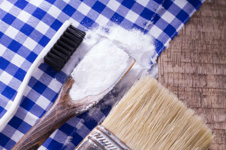 baking soda and brush are the wooden table.の写真素材