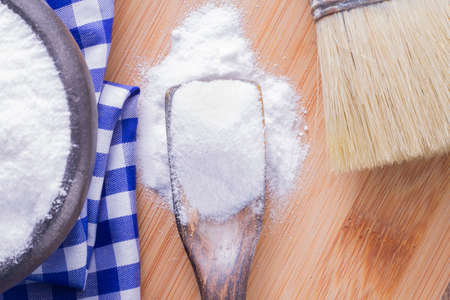 baking soda and brush are the wooden table.の写真素材