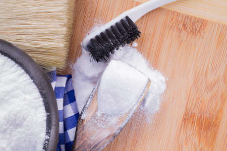 baking soda and brush are the wooden table.の写真素材