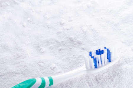 baking soda and brush are the wooden table.の写真素材