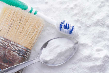 baking soda and brush are the wooden table.の写真素材
