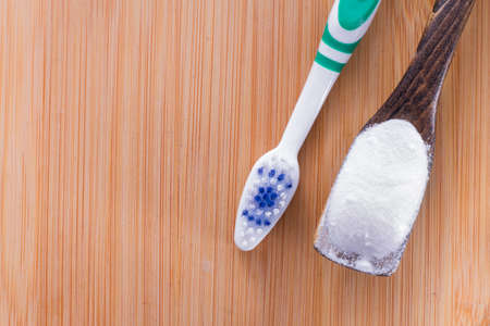 baking soda and brush are the wooden table.の写真素材
