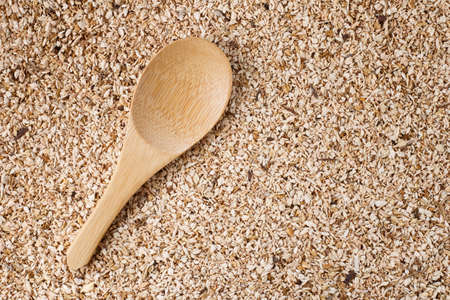 wooden spoon on wooden sawdust backgroundの写真素材