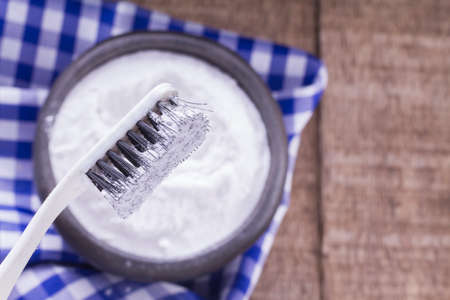 baking soda and brush are the wooden table.の写真素材