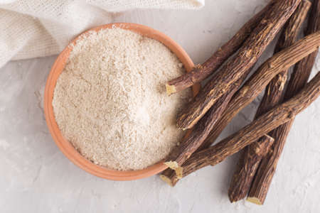 Powder and licorice root on the table - Glycyrrhiza glabra.