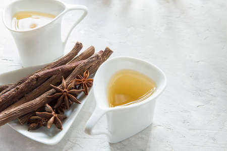 anise tea and liquorice roots on the tableの写真素材