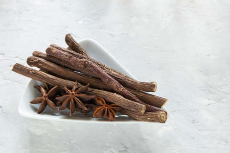 licorice and anise roots in bowl on the table.の写真素材