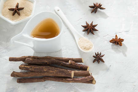 anise tea and liquorice roots on the tableの写真素材