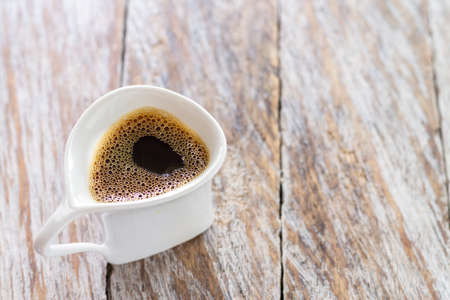cup of fresh coffee on the rustic wooden tableの写真素材
