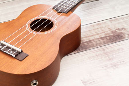 ukulele on the rustic wooden table, close upの写真素材