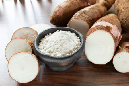Raw yucca starch on the wooden table - Manihot esculenta..の写真素材