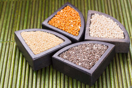 grains of super gluten-free foods: amaranth, chia, quinoa, millet in containers
