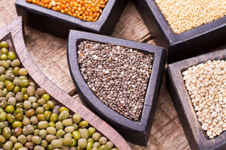 grains of super gluten-free foods: amaranth, chia, quinoa, millet in containersの写真素材