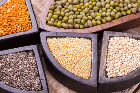 grains of super gluten-free foods: amaranth, chia, quinoa, millet in containersの写真素材