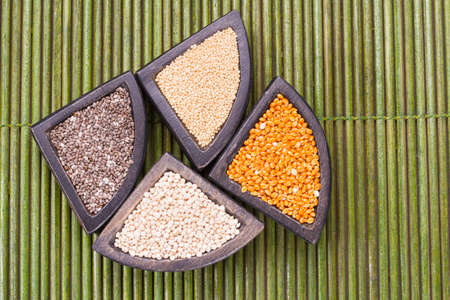 grains of super gluten-free foods: amaranth, chia, quinoa, millet in containersの写真素材