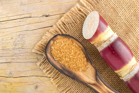 Brown sugar and cane on the table top view, image