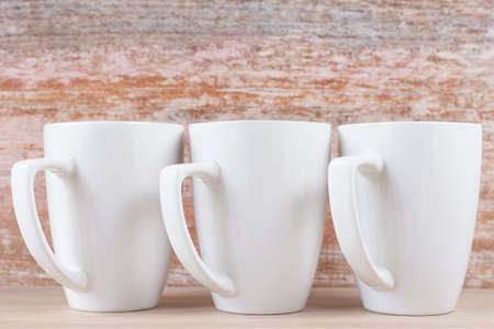 White ceramic cups on wooden background, imageの写真素材