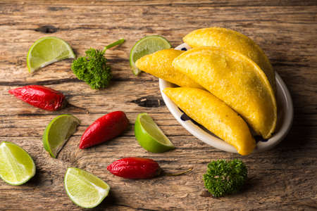Empanadas and hot pepper on wooden background, traditional Colombian foodの写真素材
