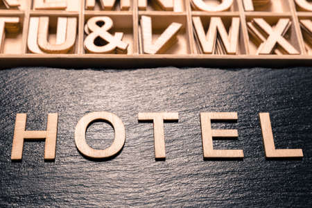 word "hotel" in wooden letters, top viewの写真素材