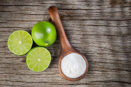 Baking soda and lemon on wooden background space for textの写真素材