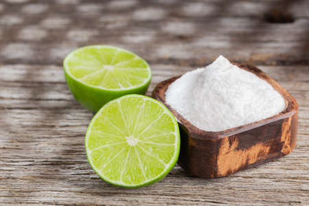 Baking soda and lemon on wooden background space for textの写真素材