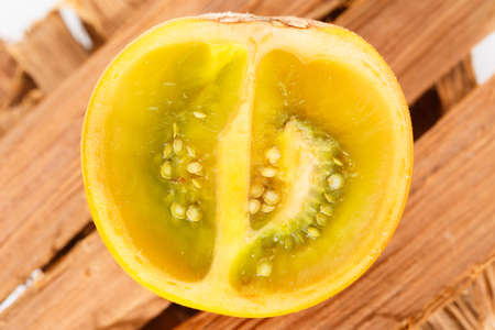 Lulo or naranjilla fruit on wood subtropical perennial plant of northwestern South America, close-up image, Solanum quitoenseの写真素材