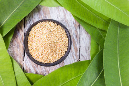 Bowl with amaranth grains on wooden background, top viewの写真素材